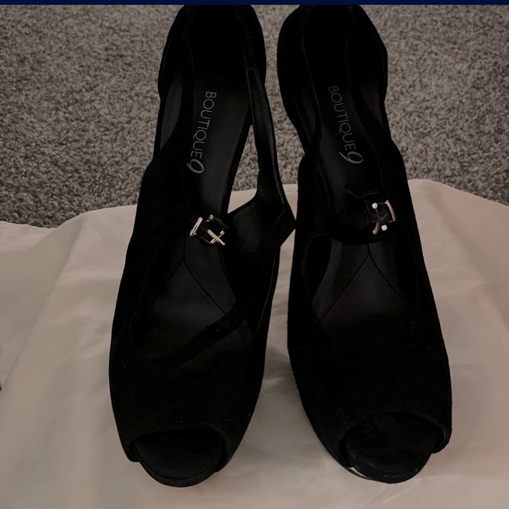 Black peep toe platform pump with silver heel. Size US 8